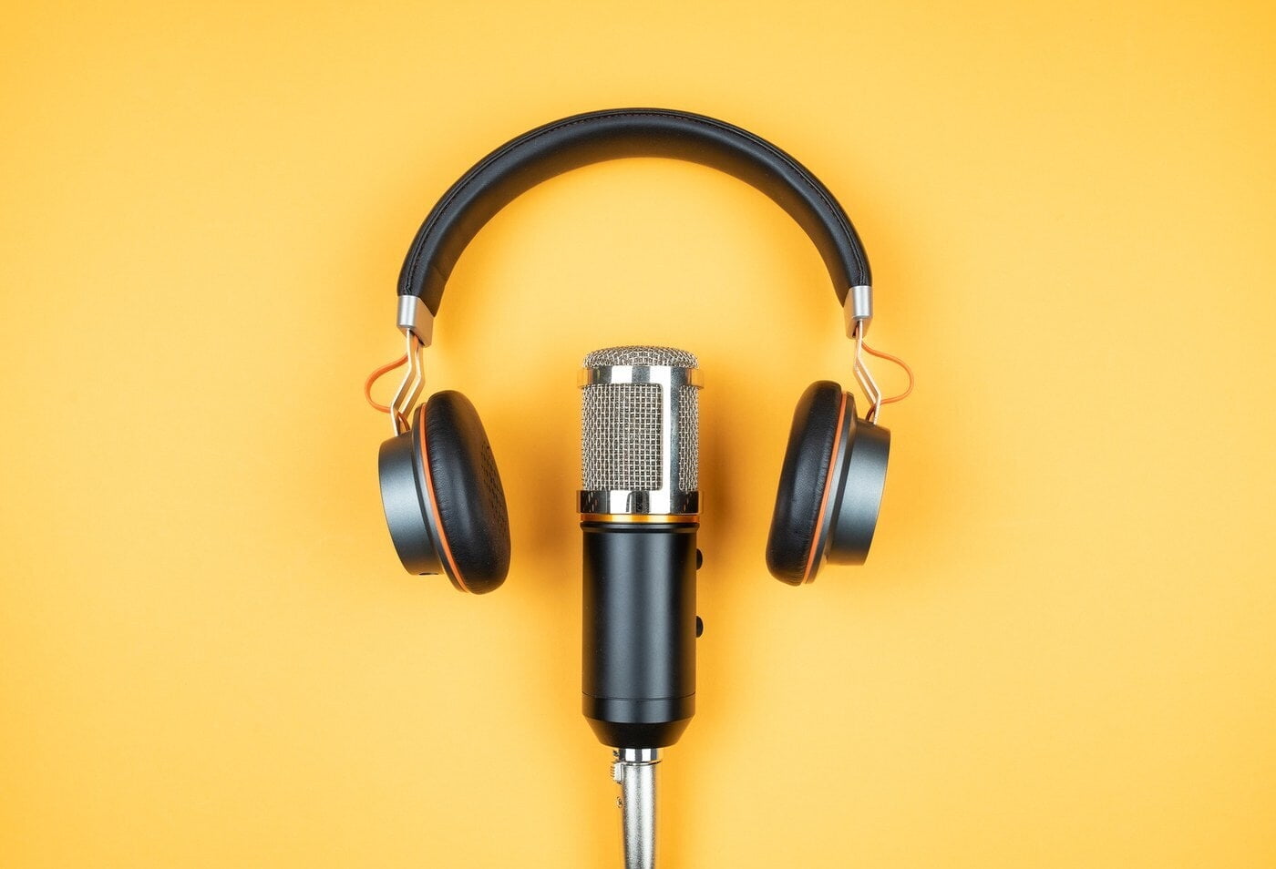 Podcast microphone and headphones representing the E:3 Podcast